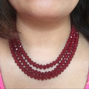 Red beaded multi strand necklace.